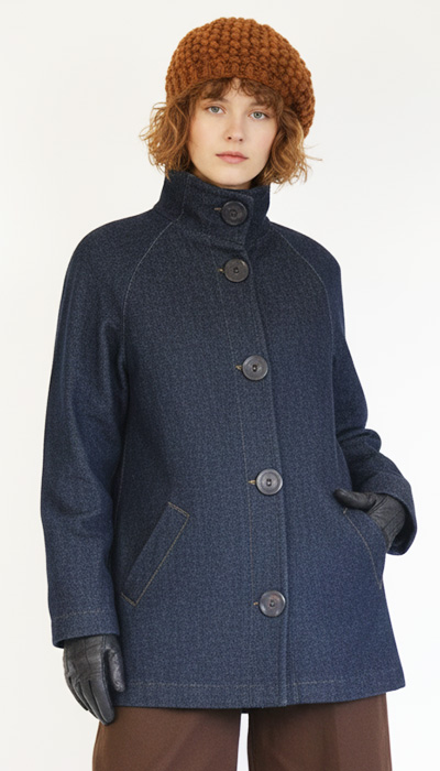 An Angela Kane PDF sewing pattern - The 682 Raglan Sleeve Jacket with Storm Collar - shown here modelled and made up in dark blue denim